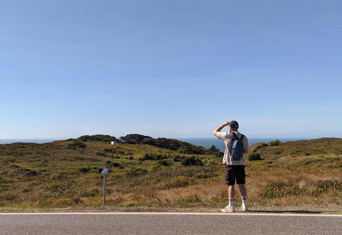 A photo of the designer behind Pher website, Ivan Perez, on a road looking at the distance.